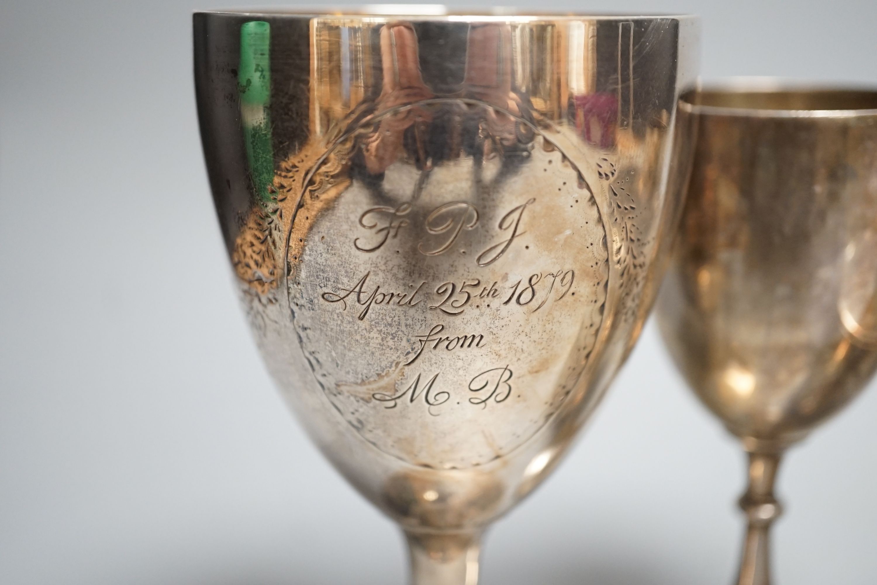 A George III engraved silver goblet, maker's mark rubbed, London, 1784, 14.6cm, together with an Edwardian silver tea caddy, a Victorian goblet, silver beaker and Brittania standard two-handle bowl by George Perkins, Lon